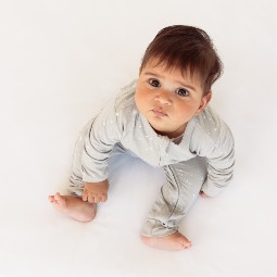 baby-boy-sitting-dressed-in-the-sleep-store-organic-cotton-ruffle-zipsuit.jpg