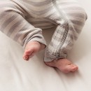 baby-feet-and-legs-wearing-a-woolbabe-merino-organic-cotton-pj-suit-pebble.jpg