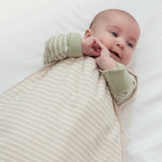 baby-wearing-woolbabe-duvet-weight-sleeping-bag-in-dune-stripe-and-pj-suit-in-meadow.jpg