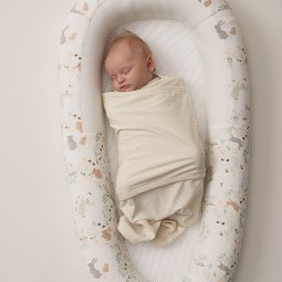 newborn-swaddled-in-miracle-blanket-fitted-swaddle-asleep-in-purflo-sleep-tight-baby-bed.jpg