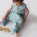 toddler-sitting-in-woolbabe-3-seasons-sleeping-suit-harbour-leaves.jpg