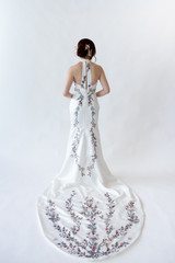 White, sexy, modern wedding cheongsam (qipao) with open back, halter neck.  A-line style with thigh side split.  Tea ceremony, Auckland, New Zealand