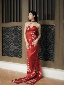 Halter neck red cheongsam gown featuring elegant floral embroidery and asymmetrical neckline. Perfect for tea ceremonies or modern cultural weddings. Available to purchase or hire at Bridal Fusion by Steph in Auckland. Under $2,000, with over 10+ styles to try on. Halter neck red cheongsam gown featuring elegant floral embroidery and asymmetrical neckline. Perfect for tea ceremonies or modern cultural weddings. Available to purchase or hire at Bridal Fusion by Steph in Auckland. Under $2,000, with over 10+ styles to try on.