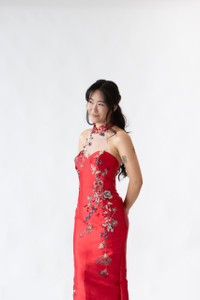 Cape - Top half.  Halter neck red cheongsam gown featuring elegant floral embroidery and asymmetrical neckline. Perfect for tea ceremonies or modern cultural weddings. Available to purchase or hire at Bridal Fusion by Steph in Auckland. Under $2,000, with over 10+ styles to try on.