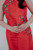 Close-up of hand-embroidered red qipao bodice with pearl and bead floral detail