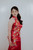 Side view of red satin qipao gown with floral train and high mandarin collar