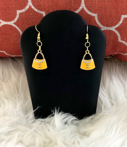 Yellow pocket book dangle earrings.
