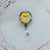 M&M Yellow badge reel