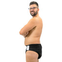 Male model wearing black adjustable diaper wrap, side-view.