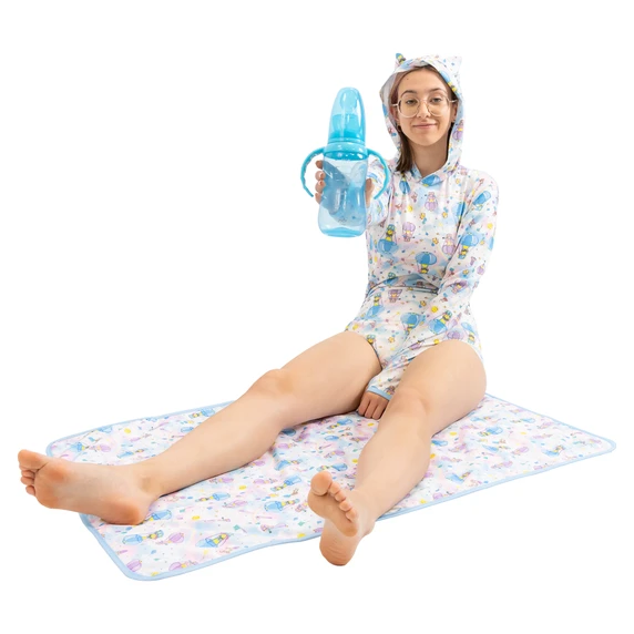 Female model holding Blue adult bottle while sitting on a Daydreamer change pad and wearing Daydreamer bodysuit.
