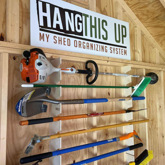 Garden Tool Organizer rack holding various yard tools in a shed with a wooden background.