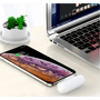 Portable charger with sleek design next to phone and laptop on white desk aicg_is_generated.