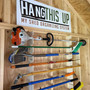 Garden Tool Organizer rack holding various yard tools in a shed with a wooden background.