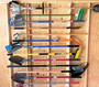 Garden Tool Organizer with various yard tools on Yard Tool Rack for shed storage organization.