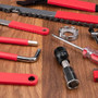 44-in-1 e-bike maintenance kit with red tools and accessories on a wooden surface for bicycle repair.