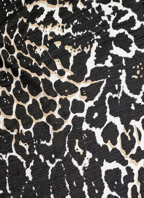 Textured animal print Yoryu chiffon crinkle fabric in black and neutral tones, showcasing the characteristic vertical ridges and lightweight drape for textile retail.