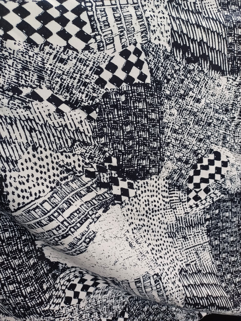 Artistic navy and white patchwork rayon challis fabric with a modern geometric sketch print featuring hatched textures and checkerboard blocks.