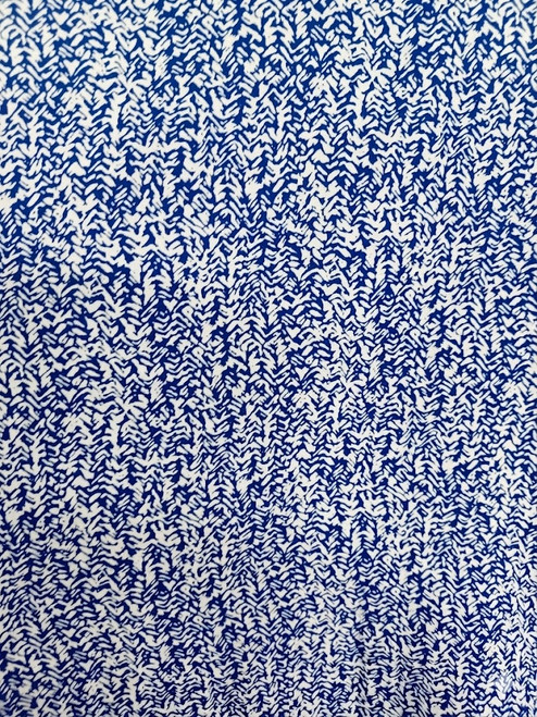 Close-up macro detail of the cobalt blue and white abstract micro-chevron pattern on the poly rayon blend fabric.