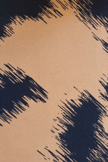 Close-up fabric shot of camel and black abstract brushstroke pattern on lightweight rayon challis.