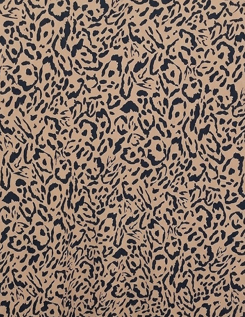 A close-up view of a fabric swatch featuring a classic, high-contrast leopard print pattern with black organic spots against a solid light tan or beige background. The texture of the rayon challis is visible, showing a soft, matte finish.