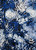The complex blue, white, and black abstract and kaleidoscope-like motifs are rendered with razor-sharp clarity and deep saturation