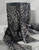 A draped display of black and tan animal print Yoryu chiffon crinkle fabric over a pedestal, showcasing its lightweight, sheer quality and elegant flow