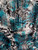 Teal and black snakeskin print Yoryu crinkle chiffon fabric showing sheer texture and vertical pleats.
