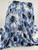 Light blue watercolor floral print Yoryu chiffon fabric with a sheer crinkle texture draped on a display.
