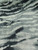 Detailed view of 100% polyester Yoryu chiffon featuring a washed watercolor zebra print in black and white with subtle, cool smoky-grey undertones and a vertical crinkle texture.