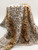 leopard-print faux fur fabric draped over a central form
