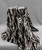 A waterfall drape of high-end patterned faux fur, revealing complex ripple folds and a luxurious gradient pattern