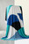Draped shot of an ITY Knit fabric featuring a modern, bold geometric print in teal, blue, black, and ivory, showcasing the fluid drape and soft, stretchable quality of the polyester dress material.