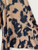 Full-view of abstract camel and black brushstroke patterned rayon challis fabric showing the scale of the print.