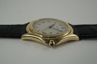 A fine preowned Cartier Cougar Panthere reference 887904 in 18k yellow gold , crafted during the 1990s. Features the standard white dial with a slight patina, black Roman numeral hours and thin outer minute railroad track, date aperture in place of the 3 o’clock, and blued-steel sword-shaped hands. The 32mm round case will suit a man or woman’s wrist, paired with a black leather strap suiting a variety of settings sitting comfortably with its 6 mm silhouette. 

Slight tarnish and scratches.
Original dial, hands and Cartier crown.
Sapphire crystal.
Case measures 32 x 38mm, 6 mm thick.
Cartier quartz jeweled movement.
Serial# 1404xxx
New premium non-Cartier black leather strap.
Cartier plated buckle.
16mm lug width.