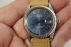 A very nice Rolex Datejust reference 1603 in stainless steel dating 1977. Features a stylish blue dial with original small print, large lume plots, silver applied stick markers and hands with lume in middle surrounded by engine turned bezel on 36mm round case. Suitable for men or women for dress casual occasions.

Light scratches on case, blue dial shows light discoloration.

Original dial, hands and crown.

Acrylic crystal.

Rolex cal. 1570, 26 jewels automatic winding.

Serial# 5262xxx

New premium non-Rolex buckskin leather strap.

20mm lug width.

Modeled on 6 inch wrist.