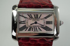 A very nice preowned Cartier Divan XL reference 2600, produced during the 2000s. This is the largest model available from Cartier’s line in a stunning configuration of pink mother of pearl dial paired with a gorgeous snake strap that radiates vibrant berry and reddish tones and faceted pink sapphire crown. Limited edition out of 500 pieces. Suitable for a number of occasions, for either a man or woman. 

Light scratches throughout, very small chip on crystal edge by 11 o’clock.  
Original pink mother of pearl dial, hands and pink sapphire crown.
Serial# 711xxxCE 
29 mm lug width. 
Cartier red snake strap (85% condition approximate), 
Cartier steel tang buckle.
Modeled on a 6 inch wrist.
