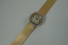 A very nice vintage Movado bracelet watch in 18k yellow gold, crafted during the late 1960s. Once retailed by Cartier, the subtle hexagonal polished case with original finish is surrounded by 28 diamonds weighing 1.12 carat total weight, houses a silver dial signed Cartier with black stick and Roman numerals and stick hands. Resembling a floral design further accentuated by a beautifully crafted integrated bracelet with a backwind function that adds to its daintiness. Suitable for casual and dressy occasions.