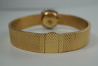 A very nice vintage Movado bracelet watch in 18k yellow gold, crafted during the late 1960s. Once retailed by Cartier, the subtle hexagonal polished case with original finish is surrounded by 28 diamonds weighing 1.12 carat total weight, houses a silver dial signed Cartier with black stick and Roman numerals and stick hands. Resembling a floral design further accentuated by a beautifully crafted integrated bracelet with a backwind function that adds to its daintiness. Suitable for casual and dressy occasions.