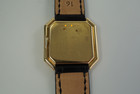 A fine Cartier Ceinture large in 18k yellow gold from the early 1970s. The case and movement are both exquisitely crafted and the hexagonal gold crown adds a fun touch to the stepped case. This piece would suit either a man or woman for a variety of settings.

Sapphire crystal shows light scratches. 

Dial has been refinished long ago.

Polished case with French hallmarks.

Jaeger caliber Cartier 18 jewel movement, mechanical wind.

Non-Cartier 16mm black leather strap. 

16 mm between lugs.