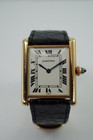 BRAND:                            Cartier 
MODEL:                            Tank
CASE MATERIAL:            18k yellow gold 
CASE MEASURES:          24 x 30 mm
MOVEMENT:                     Mechanical winding
FUNCTIONS:                    Time 
CONDITION:                     Very good
See it in our eBay store.
A beautiful vintage Cartier Tank L.C. in 18k yellow gold, crafted during the 1980s. A special and more refined version of the Tanks, with the extra flat profile, elongated sapphire crown and Paris dial. Would suit a varied wardrobe for an elegant or casual look. Modeled on size 6 inch wrist. 

Tarnishing on case, slight scratches.
Original white Roman dial signed PARIS.
Original blued hands and elongated sapphire crown. 
Case measures 24 x 30 mm, 5 mm thick. 
Cartier cal. 8061 (96), 18 jewels mechanical winding, adjusted to 5 positions. 
Original Cartier 18k deployment with black Must Cartier lizard strap, circumference measures
We will include a non-Cartier leather strap with non-Cartier buckle.
18 mm between lugs.