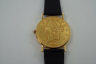 A fine Corum 20 Dollar Coin watch in 18k yellow gold, crafted during the 1990s. USA coin from 1897 exhibits little wear, with the classic ridged coin case and diamond crown. Durable for everyday wear, features a date aperture and black hands contrasting delightfully against the gold face, paired with a glossy alligator black strap. Modeled on 6 inch wrist.

Box included.
Original dial, hands and crown. 
Case measures 36 x 42 mm, 6 mm thick. 
Corum quartz, 10 jewels 
Case# 3763xx Movement# 2194xx
Sapphire crystal. 
Corum black alligator strap, unused.
Corum plated buckle. 
20mm lug width.