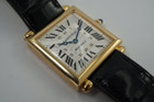 A fine preowned Cartier Tank Obus 2380 in 18k yellow gold, crafted circa 1998. The Obus is an iteration of the century-old Tank from Cartier, the name deriving from the French word “bullet” referencing the bullet-shaped lugs. The case sits prominently on the wrist without overwhelming the wearer, encompassing the silver guilloche dial, blued breguet hands black Roman numerals and blue sapphire cabochon crown. From the Collection Privée Cartier Paris line, the exhibition case back reveals the Cartier movement with special attention to interlocking C logo design making this an excellent piece for the collector’s repertoire. Modeled on 6 inch wrist.

Light tarnish.
Includes CPCP inner and outer box, and papers.
Original guilloche dial, blued breguet hands and Cartier crown. 
Case measures 26.5 x 33.5 mm, 8 mm thick. 
Cartier cal. 1585MC, 18 jewel mechanical.
Serial# CC451xxx Movement# 0843
Sapphire crystal. 
Cartier black crocodile strap (85% condition).
Cartier 18k yellow gold buckle. 
17 mm lug width.