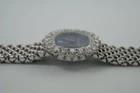 A fine vintage Audemars Piguet opal and diamond bracelet watch in 18k white gold, crafted during the 1980s. A stunning oval accessory for the fiery gem quality opal dial Audemars is renowned in selecting for their fine pieces, surrounded by round brilliant cut diamonds. Both the opal and diamonds catch the light in a way that refracts a glitter of rainbow colors. This piece will dazzle the wearer and suit a variety of occasions, its interlinked chain bracelet wearing comfortably on the wrist. Modeled on 6 inch wrist.

The opal has faint crack at 4 o’clock position that is imperceptible with the naked eye due to the competing opal. Light scratch on center crystal. 
Factory round cut .10 carat diamond set bezel; 2 carats total approximate.
Original opal dial, hands and crown. 
Case measures 21.5 x 22.5 mm, 6.5 mm thick. 
AP cal. 2430, 18 jewel backwind set movement. 
Case# 194xx Movement# 2636xx
Sapphire crystal. 
AP signed bracelet, measures and fits 6 3/4 inches or 17cm approximate, 12mm wide.