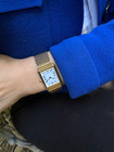 A fine preowned Cartier Tank Grains of Rice in 18k yellow gold, crafted during the 1990s. A special edition of the popular and enduring Tank model for its bracelet charmingly described as grain or beads of rice. The classic white Roman dial with blued steel hands paired with the bracelet serves a dressy look, alternatively a leather strap will tone it down  for more casual feel. Wonderfully drapes the wrist and is comfortable to wear, suitable for men or woman. Modeled on 6 inch wrist.

Light scratches and small nick on crystal. 
Original dial, hands and sapphire crown. 
Case measures 23.5 x 31 mm, 6 mm thick. 
Sapphire crystal. 
Cartier quartz movement. 
Serial# 810522xxx
Cartier bracelet has been previously fitted. Fits 6 1/2 inch or 17 cm approximate.
New non-Cartier black leather strap.
17.5 wide.