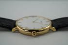 A very nice preowned Piaget watch in 18k yellow gold reference 8035, crafted during the 1990-2000s. A classic configuration of understated gold round smooth case, white dial and gold applied hours and Roman numerals. This piece will take you from executive look to a casual occasion, featuring an ultra-thin profile and paired with a black strap. Suitable for men or women.

Minimal scratches. 
Original dial, hands and crown.
Case measures 32.5 x 35 mm, 4.5mm thick. 
Piaget cal. 858P quartz movement. 
Case# 594500 Movement# 9901021 
Sapphire crystal. 
Piaget black crocodile strap (80% condition approximate).
Piaget 18k gold buckle.
17mm lug width.