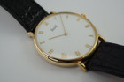 A very nice preowned Piaget watch in 18k yellow gold reference 8035, crafted during the 1990-2000s. A classic configuration of understated gold round smooth case, white dial and gold applied hours and Roman numerals. This piece will take you from executive look to a casual occasion, featuring an ultra-thin profile and paired with a black strap. Suitable for men or women.

Minimal scratches. 
Original dial, hands and crown.
Case measures 32.5 x 35 mm, 4.5mm thick. 
Piaget cal. 858P quartz movement. 
Case# 594500 Movement# 9901021 
Sapphire crystal. 
Piaget black crocodile strap (80% condition approximate).
Piaget 18k gold buckle.
17mm lug width.