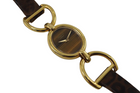 A beautiful vintage Chopard ladies stirrup style watch in 18k yellow gold, crafted circa 1970s. A stunning accessory featuring an eye-catching tiger eye face encased in an oval case, fastened to stirrup hoop style lugs and an understated leopard strap tonally complementing the tiger eye. The stirrup hoop with slim strap reminiscent of Hermes and Gucci, a popular style during its time, wears comfortably on the wrist and would suit a variety of occasions. 

Light scratches on case, natural striations on stone dial.
Original tiger eye dial, hands and L.U.C. crown. 
Case measures 23 x 25mm, 69mm stirrup end to end, 7mm thick.
Chopard L.U.C. cal. 2512 ETA, 17 jewel mechanical winding.
Case# 937xx
Sapphire crystal.
Leather print strap, believed to be the original style (70% condition approximate). 
Gold plated buckle.
11mm lug width.
Modeled on 6 inch wrist.