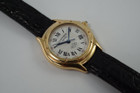 A very nice Cartier Panthere Cougar reference 1171-1 in 18k yellow gold, crafted in 1997. A special limited edition accessory commemorating 150 years of its inception in 1847, featuring a special dial with L heart C inside an inverted diamond, red numerals on sweep seconds, blued steel hands, glossy black Roman hour numerals, sapphire cabochon and date aperture at 3 o’clock position. Despite its diminutive 23mm case, the dial will garner a double take and wears quite comfortably on the wrist with its low profile.

Light scratches on case.
Original commemorative 1847 150th anniversary dial, blued steel hands and sapphire cabochon crown. 
Case measures 26 x 31mm, 6.5mm thick.
Cartier quartz movement. 
Serial# C283xx 
Sapphire crystal.
Cartier black crocodile strap (85% condition, approximate).
Cartier 18k yellow gold buckle. 
12mm lug width.
Modeled on 6 inch wrist.