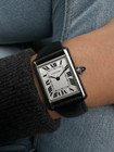 A fine Cartier Tank Must reference WSTA0042 in stainless steel, produced in 2023. A complete set with boxes and card, this enduring accessory from Cartier’s iterations of Tank models features the standard silvered dial, secret Cartier logo at 10 o’clock, black Roman numerals and chemin de fer, blued-steel sword-shaped hands and elongated blue spinel cabochon beaded crown. Classic and simple configuration of steel case and black leather strap will suit a variety of occasions with a comfort fit. 

Minimal scratches. 
Original dial, hands and crown. 
Case measures 22 x 30mm, 7mm thick.
Serial# 4322361xxxX
16 mm lug width. 
Cartier black leather strap (95% condition approximate). 
Cartier steel tang buckle.
16mm lug width.
Modeled on a 6 inch wrist.