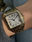 A fine Cartier Panthere reference 1060 in 18k yellow gold, crafted during the 1990s. In near mint condition, this accessory features a white dial, black Roman numerals and chemin de fer, blued steel sword hands, date aperture and inconspicuous written Cartier at 10 o’clock with a blue spinel cabochon. Wears as jewelry for its beautiful gold bracelet with hidden clasp and low silhouette square case for a comfort fit. From day to night, suitable for all dress occasions for either a man or woman. 

Original box shows interior wear. 
Original dial, hands and crown. 
Case measures 28 x 38mm, 6mm thick.
Sapphire crystal. 
Serial# CC165xxx
Cartier 18k yellow gold bracelet, full size and tight bracelet with no stretch (fits 7 1/4 inch or 18.4 cm). 
15mm lug width.
Modeled on a 6 inch wrist.